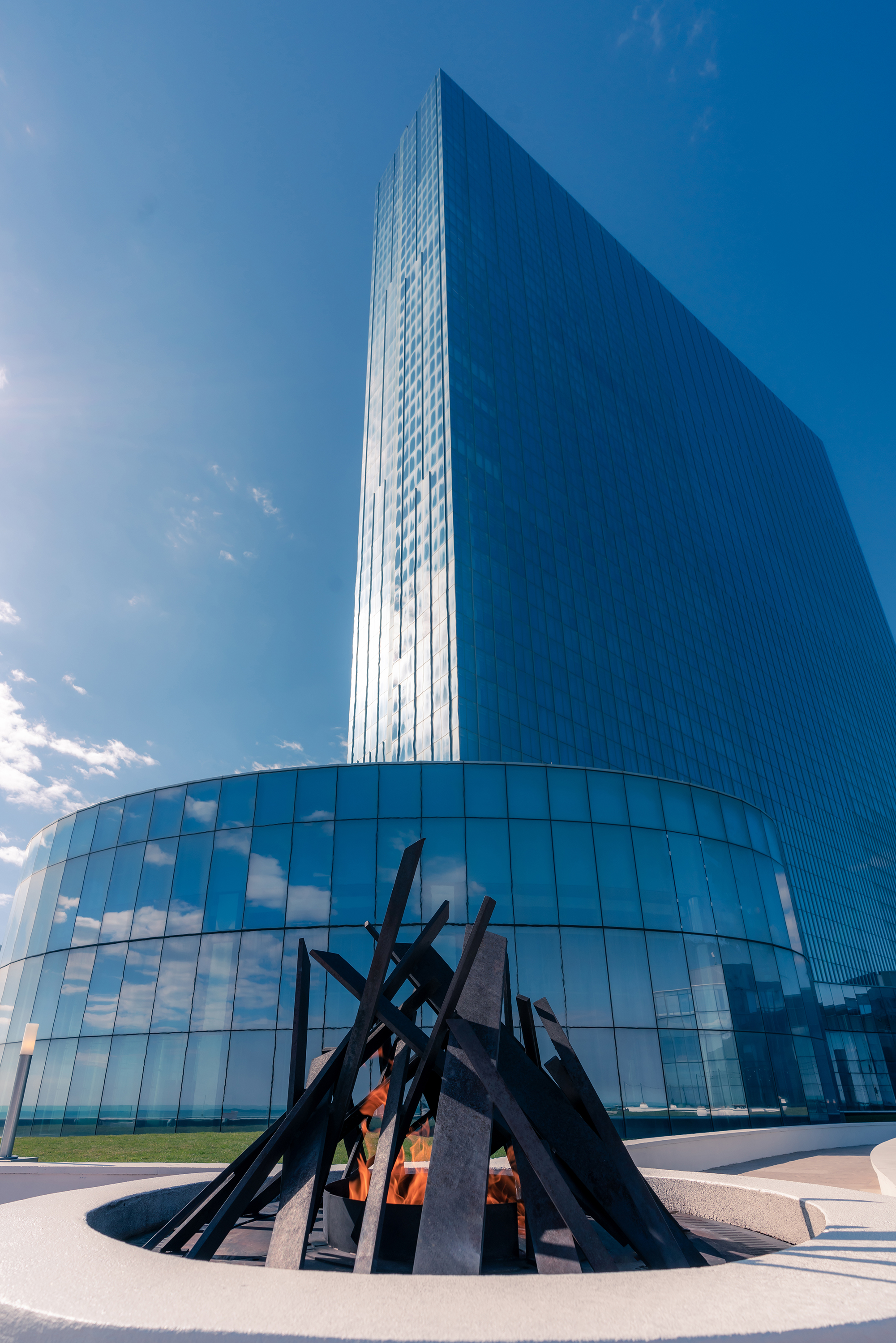 Exterior view of Ocean Casino Resort with a modern glass tower and outdoor fire feature on a clear winter day