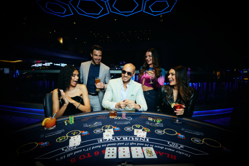 Friends playing blackjack and enjoying cocktails at Ocean Casino Resort casino floor