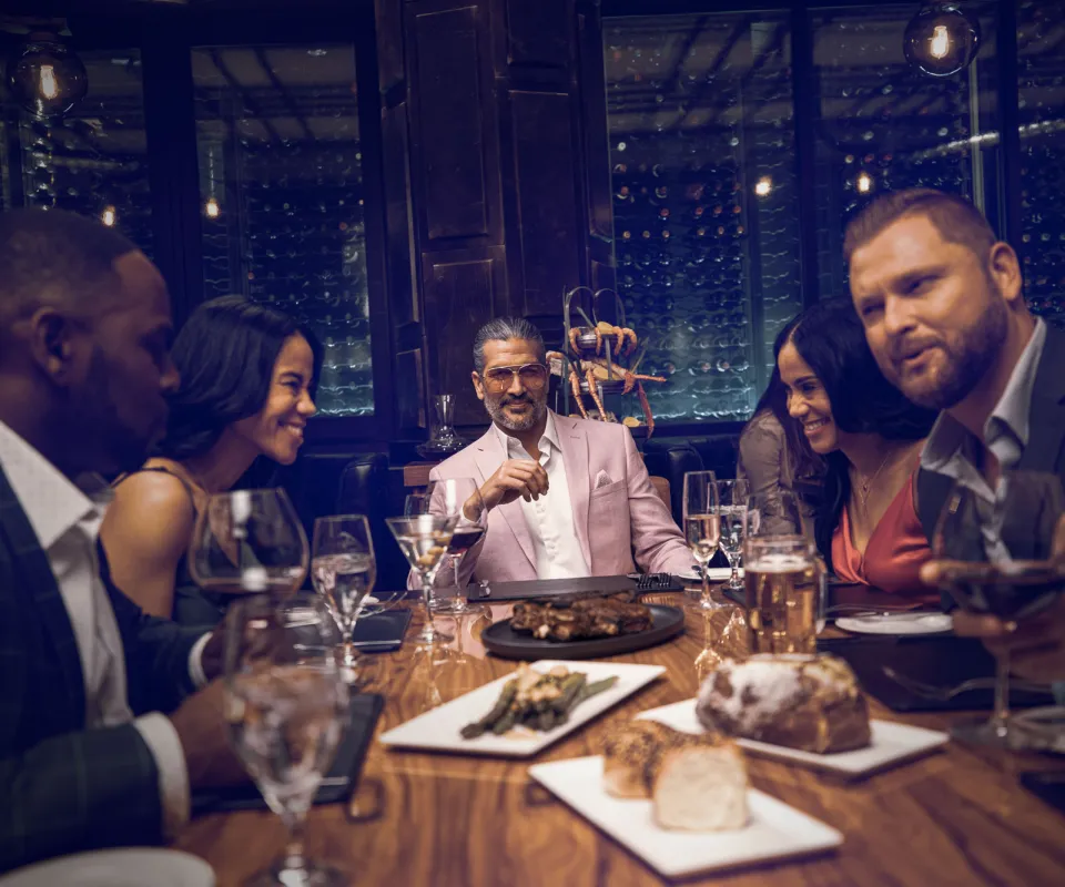 a group of adults having a steak dinner
