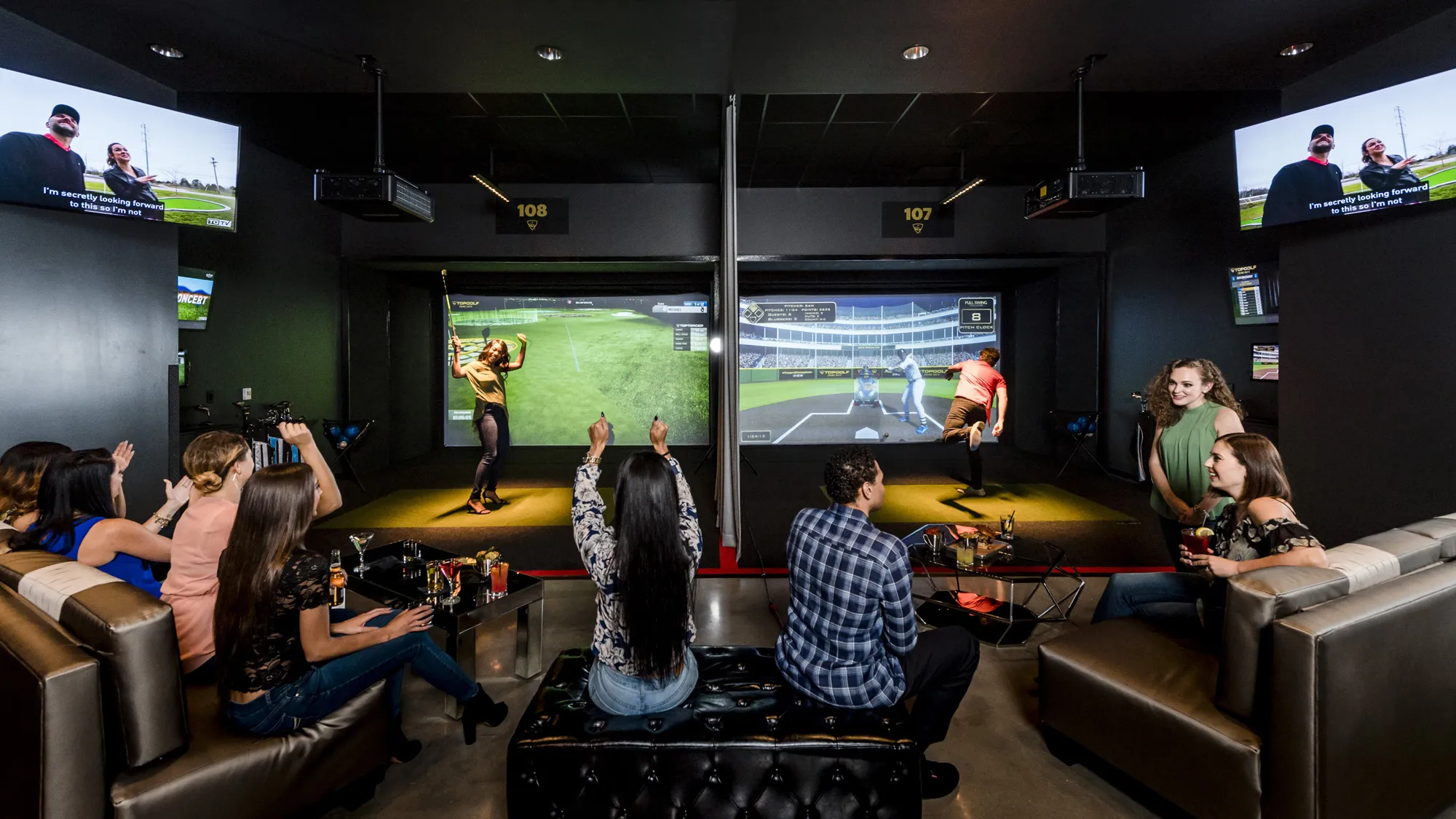 group of adults playing virtual games in the Top Golf Swing Suite