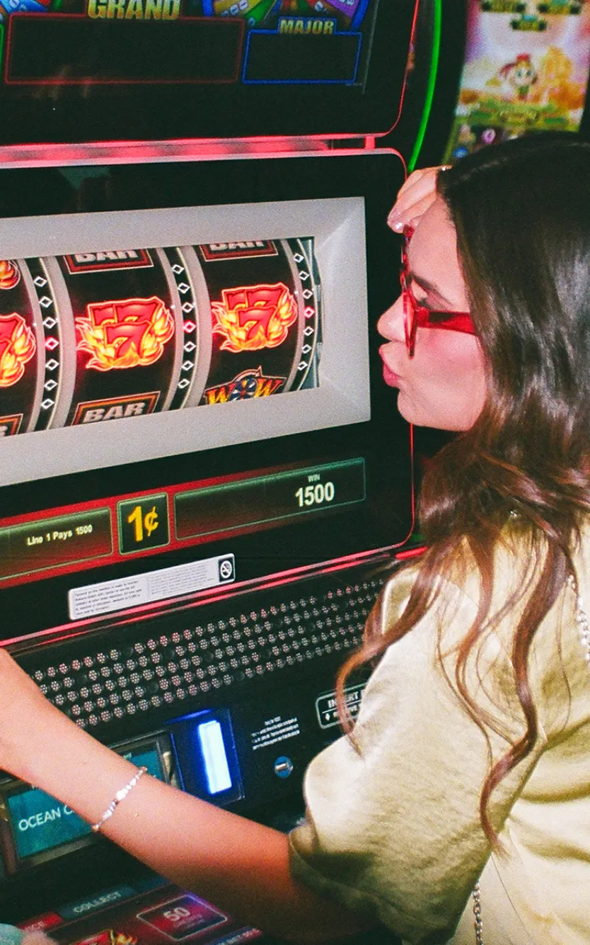 Girl kissing slot machine for good luck