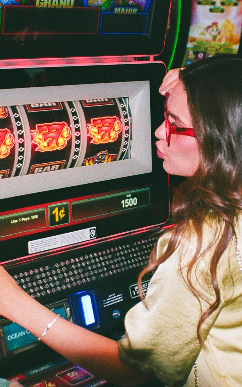 Girl kissing slot machine for good luck