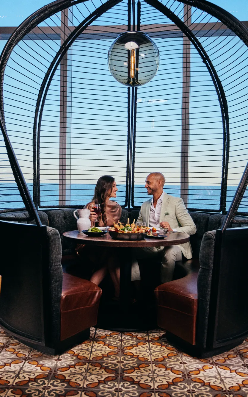 A couple sitting at a table in Amada at Ocean Casino Resort