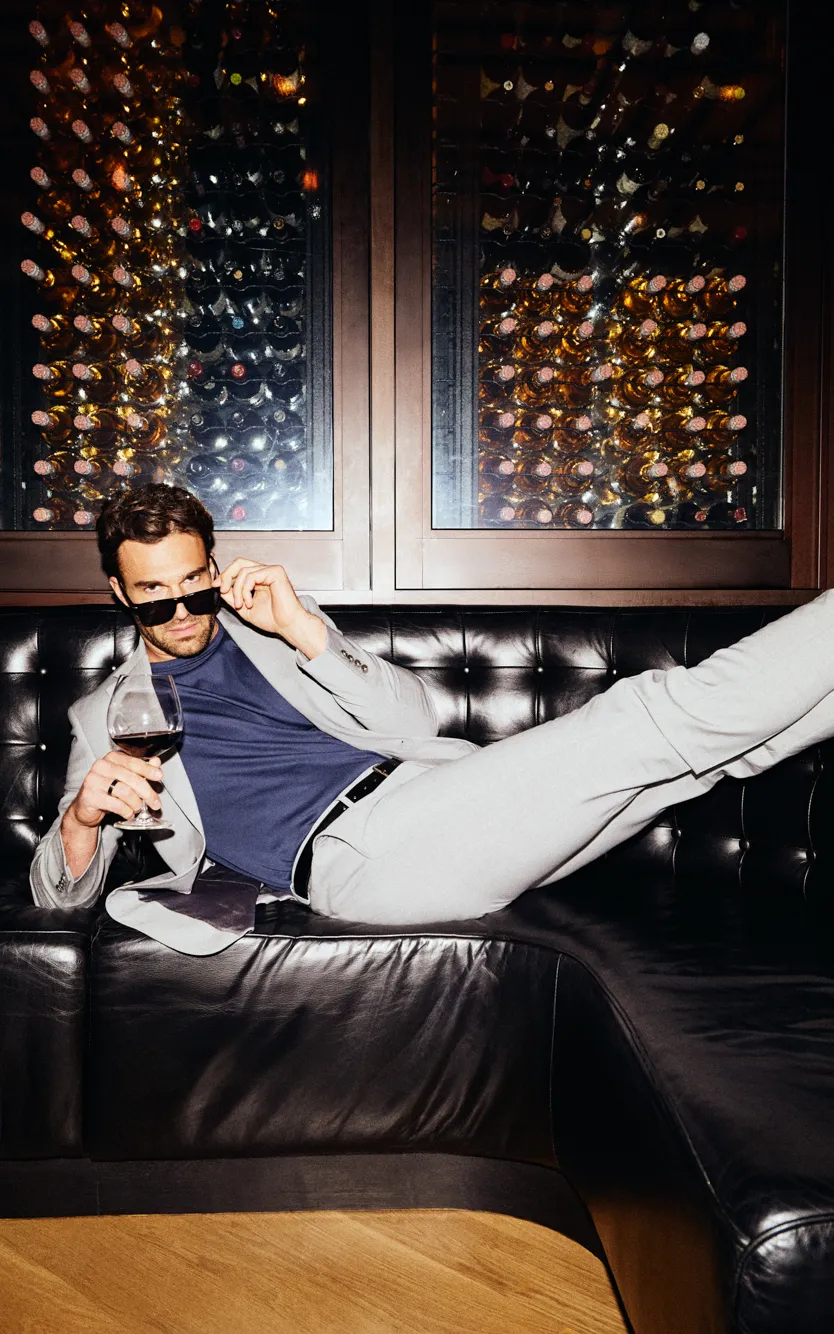 A man laying on the couch in at the SteakBar