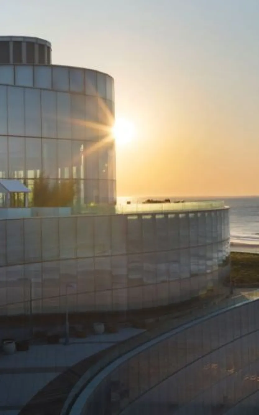 Exterior of Ocean Casino Resort with the sunrise and logos of different charities