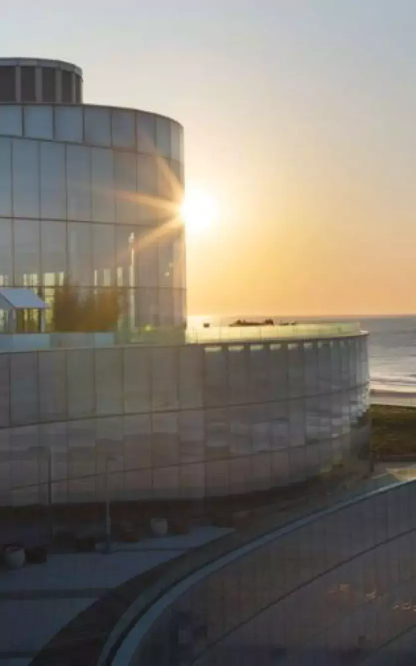Exterior of Ocean Casino Resort with the sunrise and logos of different charities