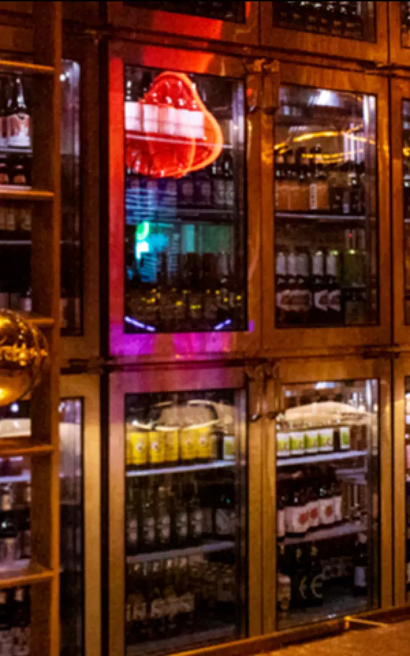 Bar at Villain and Saint with cabinets of alcohol and taps