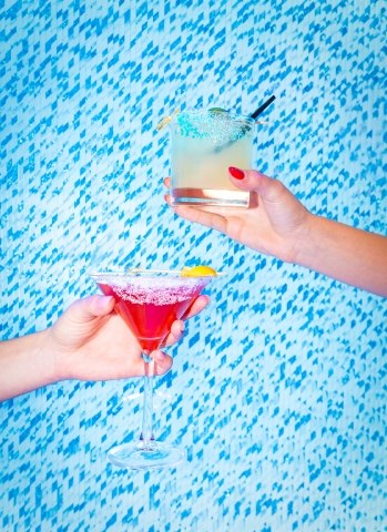 Colorful cocktails held by guests at Ocean’s 18 Mini Golf & Bar, an indoor mini golf experience in Atlantic City