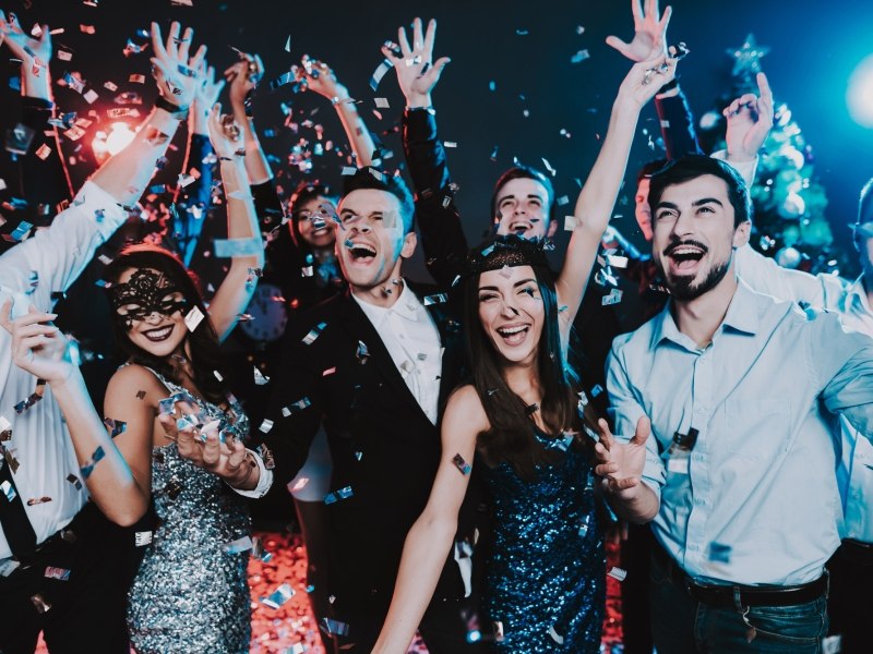 group of young adults celebrating at a holiday party