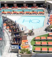 Aerial view of HQ² Dayclub at Ocean Casino Resort, featuring a sparkling pool surrounded by orange loungers and private cabanas.