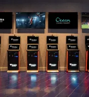 Fanatics Sportsbook self-service betting kiosks at Ocean Casino Resort with live sports displayed on overhead screens for easy in-person wagering.