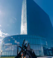 Exterior view of Ocean Casino Resort with a modern glass tower and outdoor fire feature on a clear winter day