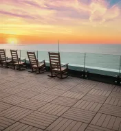 Rocking chairs overlooking the Atlantic Ocean at sunset from The Park at Ocean Casino Resort.