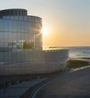 Image of exterior of Ocean Casino Resort with Ocean Cares logo and logos of several non-profit organizations
