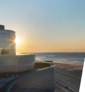 The exterior of Ocean Casino Resort and "The Arc" logo