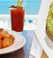 Two-image collage with breakfast dishes including eggs, potatoes, a bloody mary and avocado toast