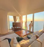 Three-image collage of friends on couch, a couple in the hotel room looking out the window, and an influencer walking up a flight of stairs