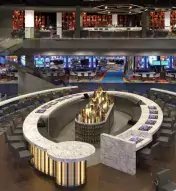High-level view of The Gallery sports-betting venue with gaming tables, big screens and lounge areas