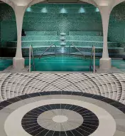 Tiled lounge area in with archways leading to spa pool
