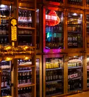 Bar at Villain and Saint with cabinets of alcohol and taps