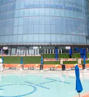 HQ2 Beachclub pool deck with lounge chairs and building in the background