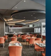 Sleek, modern dining room with tables and chairs and the {ma-kai} logo