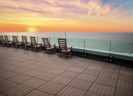 Rocking chairs overlooking the Atlantic Ocean at sunset from The Park at Ocean Casino Resort.