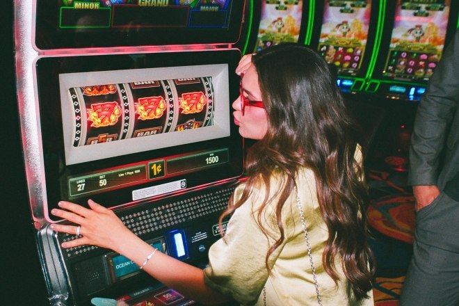 Girl kissing slot machine for good luck